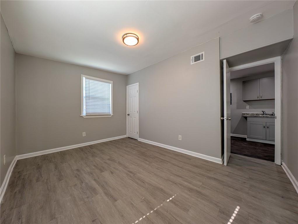 1672 Thornton Place Southwest Atlanta, GA 30315 - Photo 26 of 35 a view of an empty room with a window and wooden floor