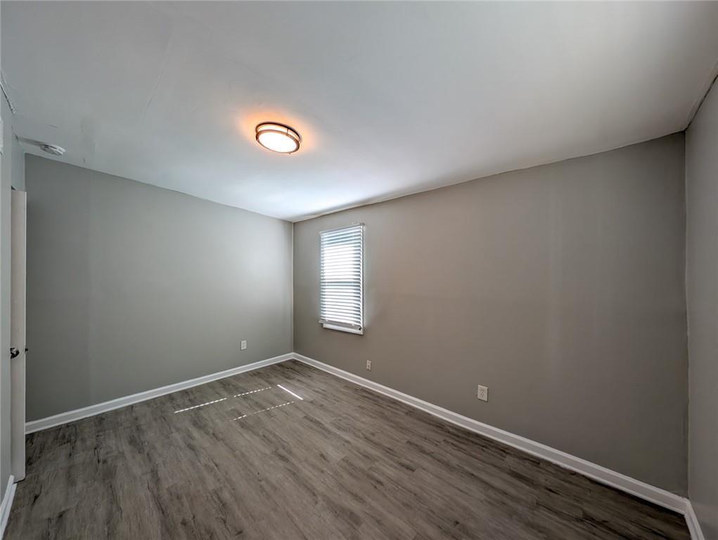 1672 Thornton Place Southwest Atlanta, GA 30315 - Photo 27 of 35 a view of an empty room with wooden floor and a window
