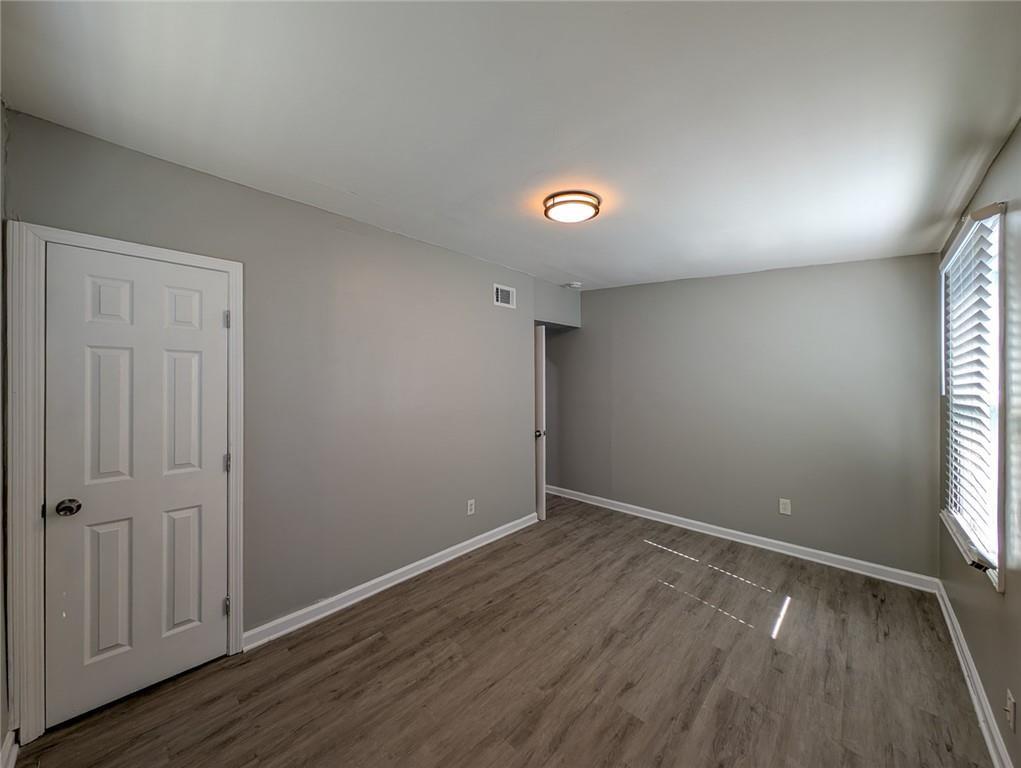 1672 Thornton Place Southwest Atlanta, GA 30315 - Photo 28 of 35 an empty room with wooden floor and windows
