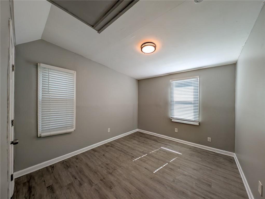 1672 Thornton Place Southwest Atlanta, GA 30315 - Photo 29 of 35 an empty room with wooden floor and windows