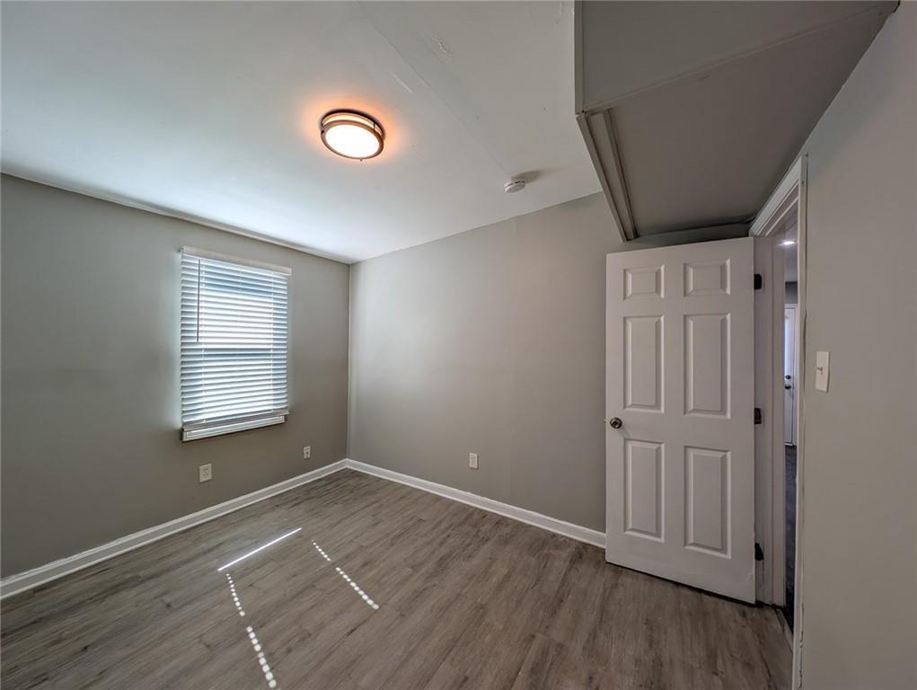 1672 Thornton Place Southwest Atlanta, GA 30315 - Photo 32 of 35 a view of an empty room with wooden floor and a window