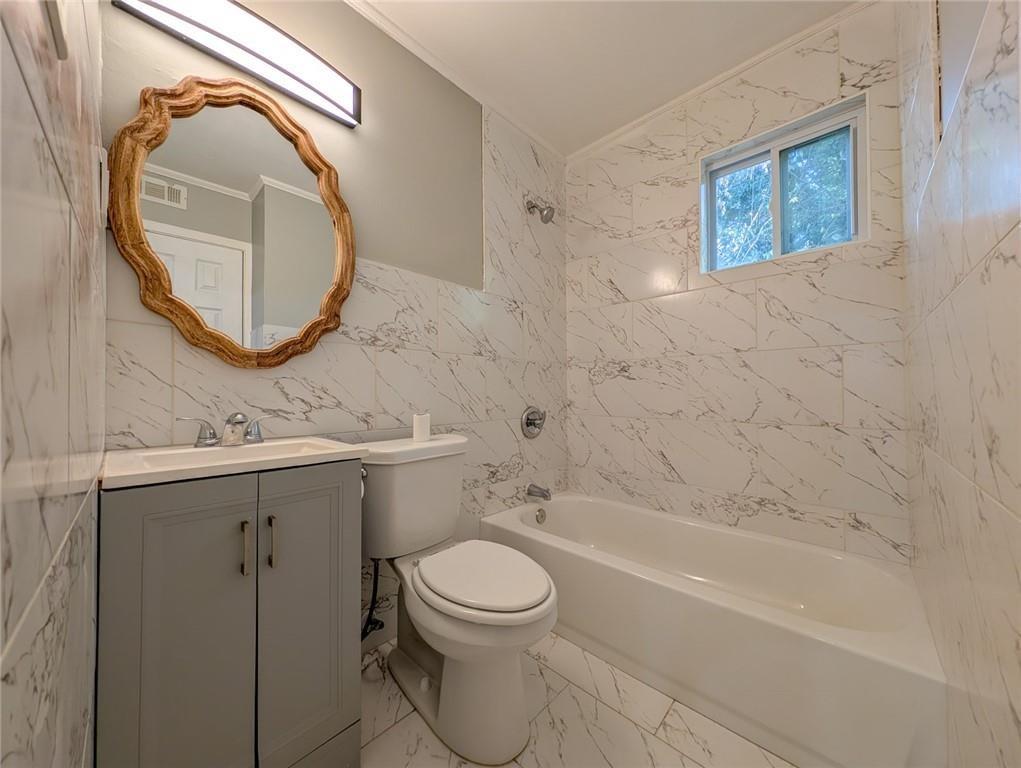 1672 Thornton Place Southwest Atlanta, GA 30315 - Photo 33 of 35 a bathroom with a toilet sink and mirror