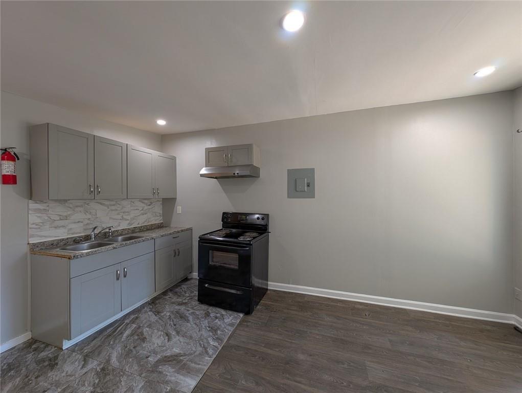 1672 Thornton Place Southwest Atlanta, GA 30315 - Photo 6 of 35 a kitchen with granite countertop a sink and a stove top oven