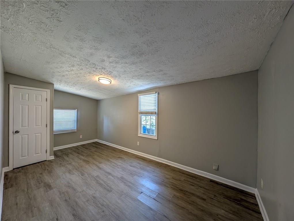 1672 Thornton Place Southwest Atlanta, GA 30315 - Photo 10 of 35 an empty room with wooden floor and windows