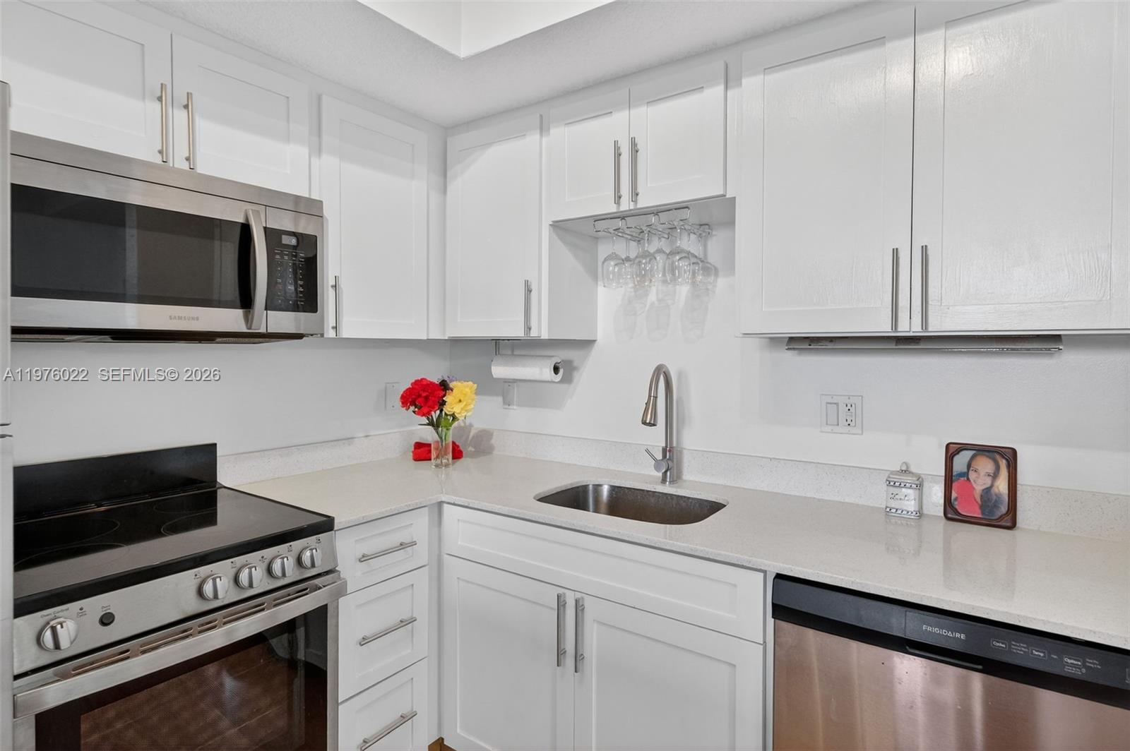 2630 Southwest 28th Street, Unit 51 Miami, FL 33133 - Photo 1 of 35 a kitchen with stainless steel appliances white cabinets and a sink