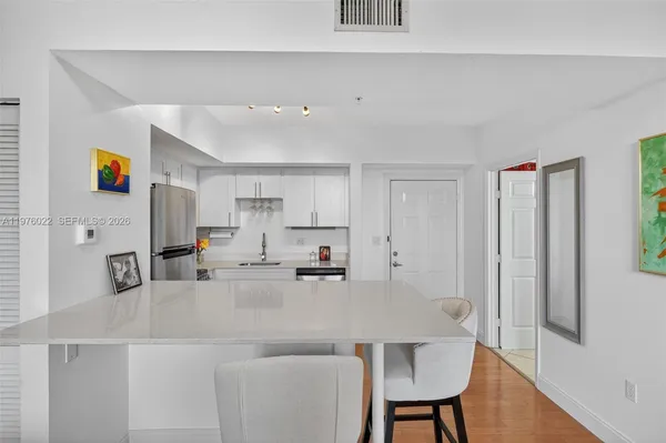 a kitchen with stainless steel appliances kitchen island granite countertop a sink and cabinets
