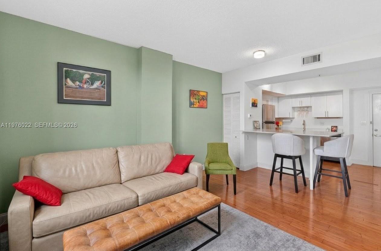 2630 Southwest 28th Street, Unit 51 Miami, FL 33133 - Photo 15 of 33 a living room with furniture kitchen view and a dining table