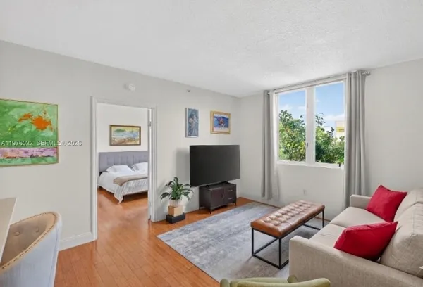 a living room with furniture and a flat screen tv