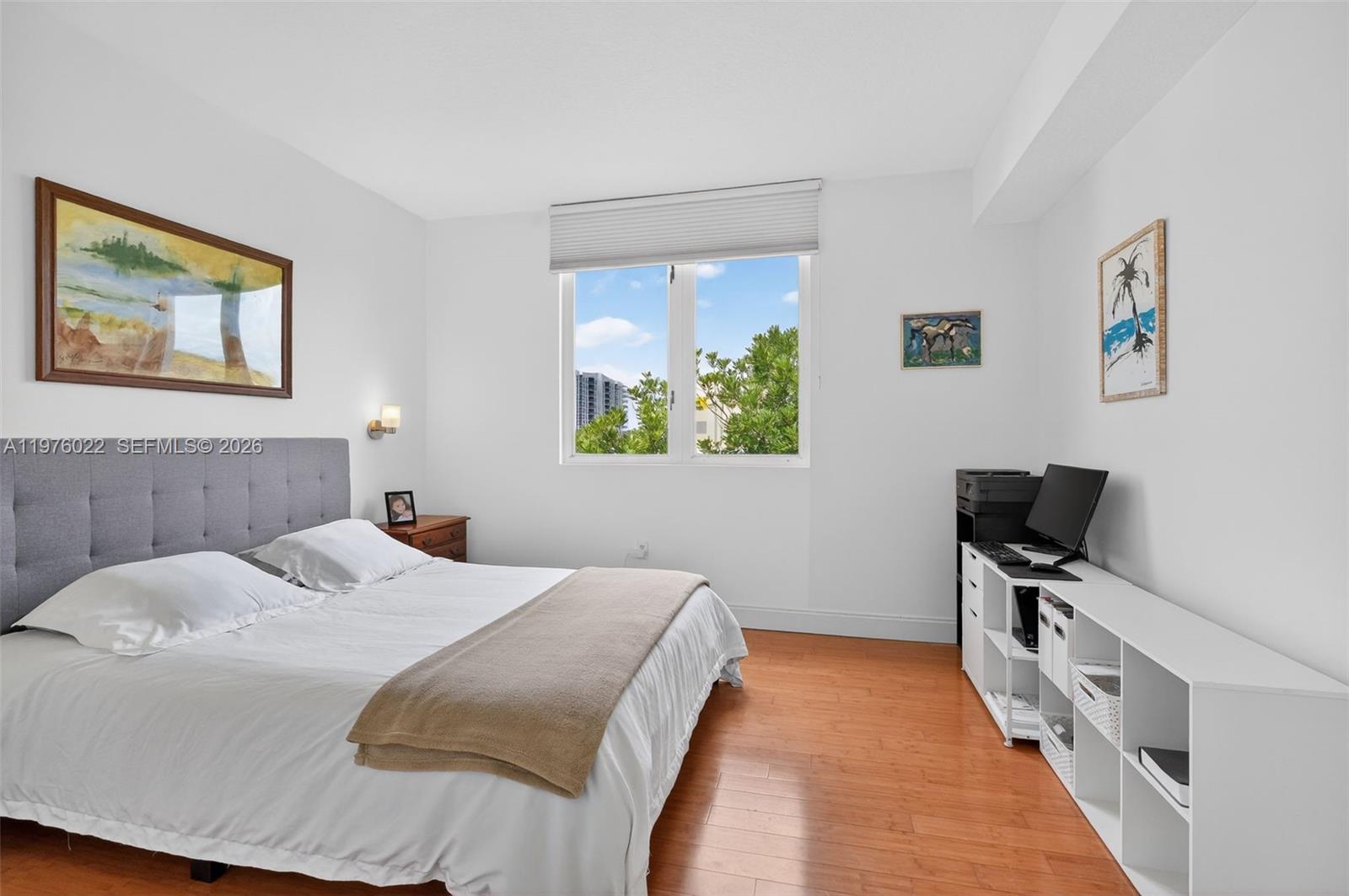 2630 Southwest 28th Street, Unit 51 Miami, FL 33133 - Photo 18 of 33 a bedroom with a bed and a flat screen tv