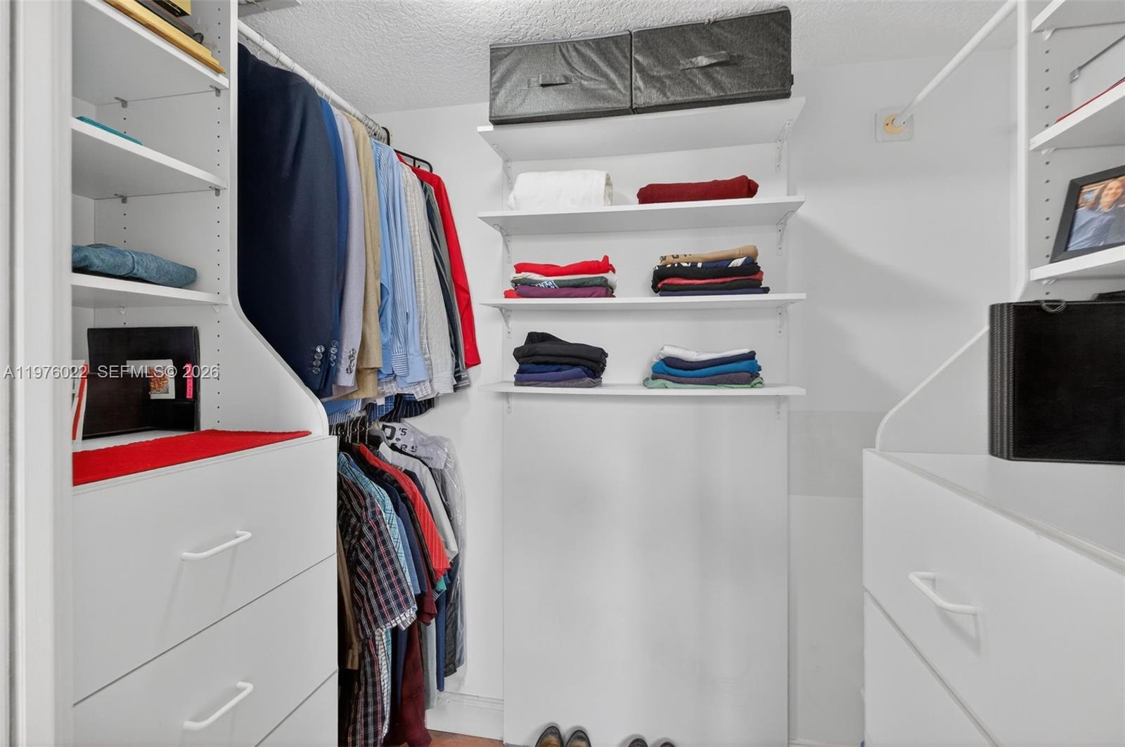 2630 Southwest 28th Street, Unit 51 Miami, FL 33133 - Photo 20 of 33 a view of walk in closet with clothes and shoes