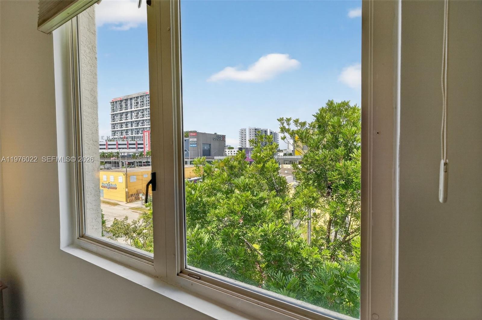 2630 Southwest 28th Street, Unit 51 Miami, FL 33133 - Photo 23 of 35 a view of a glass door with a outdoor space