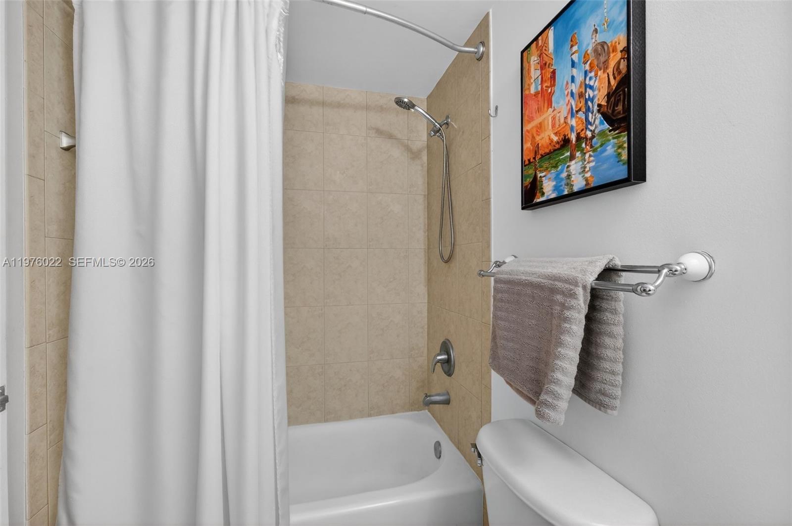 2630 Southwest 28th Street, Unit 51 Miami, FL 33133 - Photo 25 of 35 a bathroom with a shower curtain
