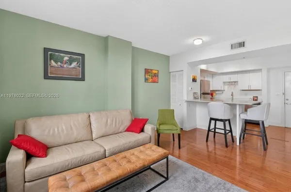 a living room with furniture kitchen view and a dining table