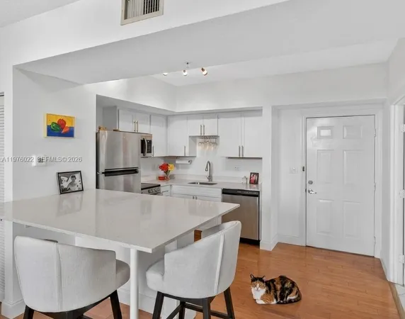 a kitchen with refrigerator and cabinets