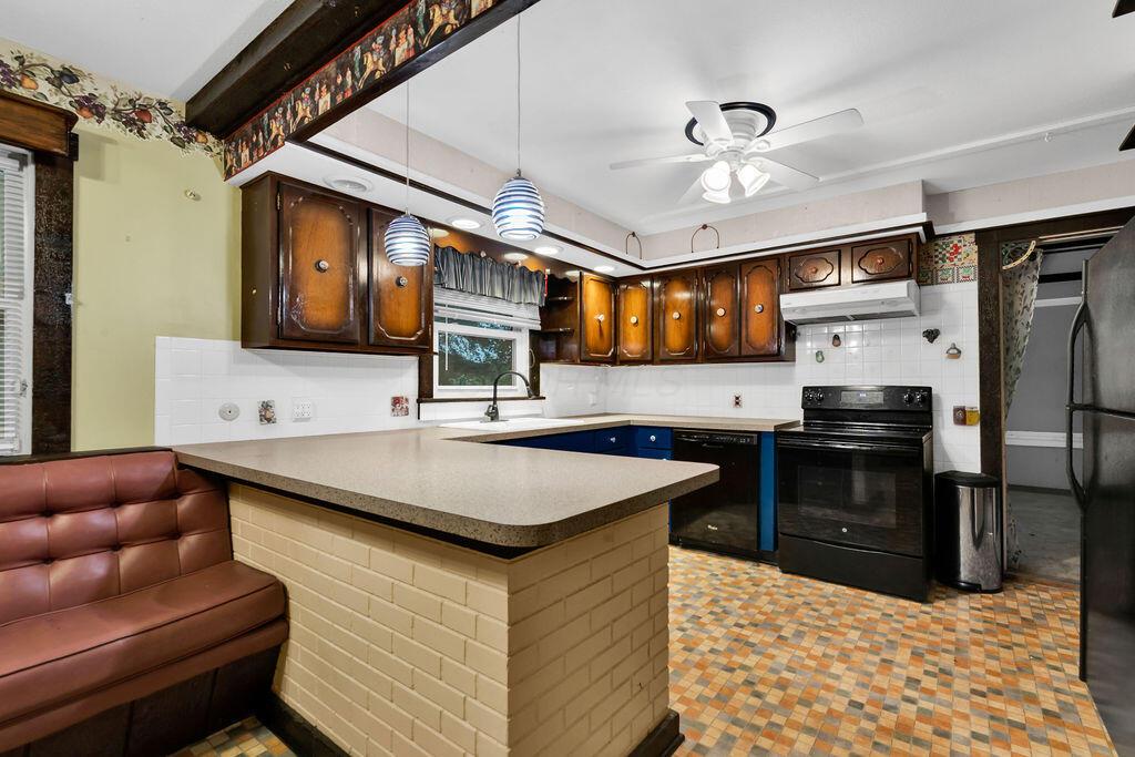 4409 Newton Road Northeast Newark, OH 43055 - Photo 10 of 87 • Neutral vinyl flooring • Ivory painted walls • Lighted ceiling fan • Ceramic tile backsplash • Electric range • Refrigerator • Dishwasher • Double bowl sink • Step-in pantry closet • Range hood