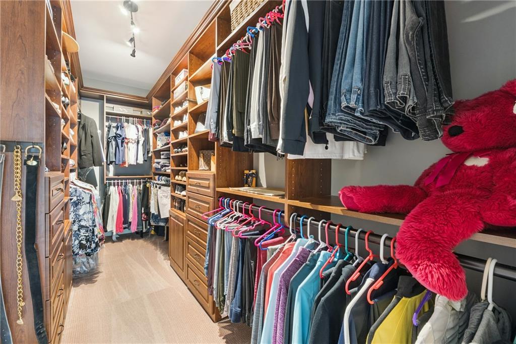 217 Trecastle Square Canton, GA 30114 - Photo 11 of 43 a view of walk in closet with clothes and shoes