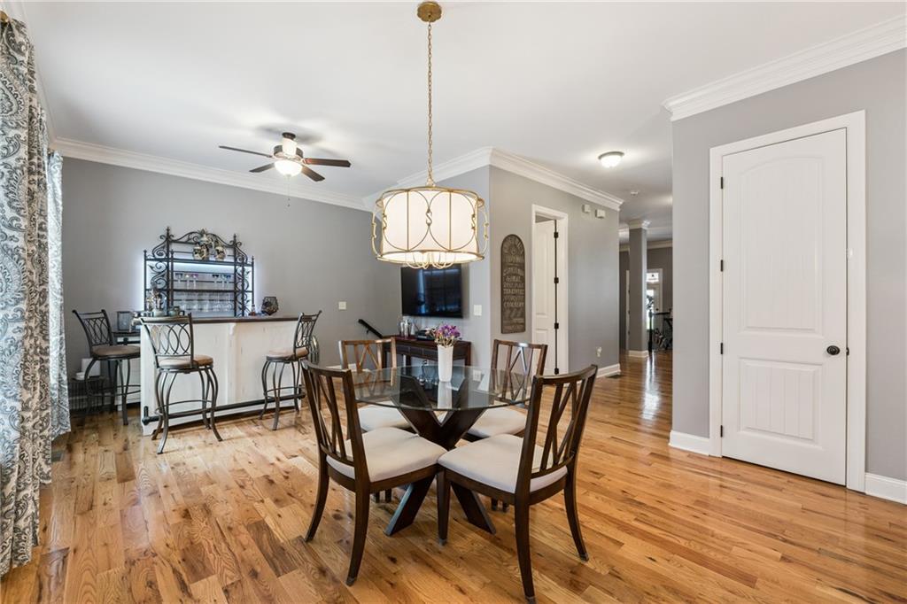 217 Trecastle Square Canton, GA 30114 - Photo 26 of 43 a view of a dining room with furniture and wooden floor