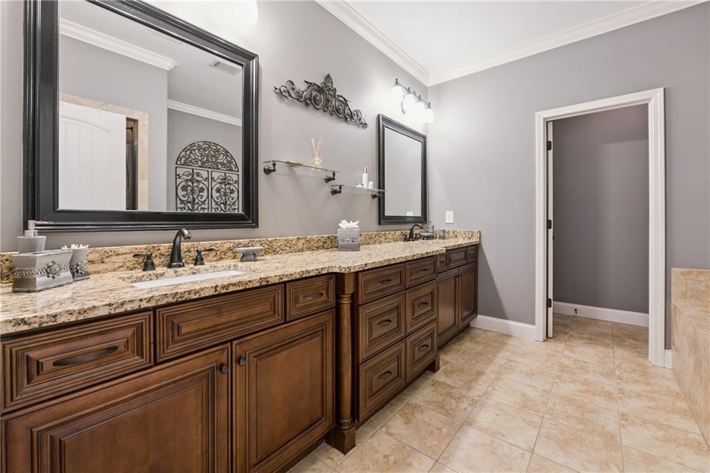 217 Trecastle Square Canton, GA 30114 - Photo 8 of 43 a spacious bathroom with a granite countertop double vanity sink mirror and