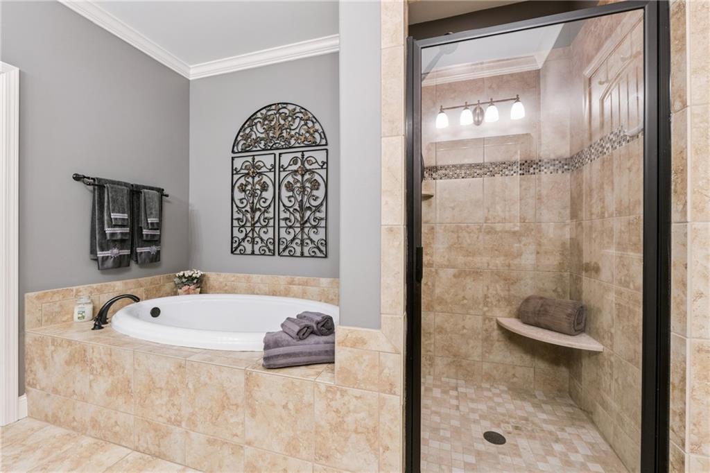 217 Trecastle Square Canton, GA 30114 - Photo 10 of 43 a bathroom with a tub a sink and glass door