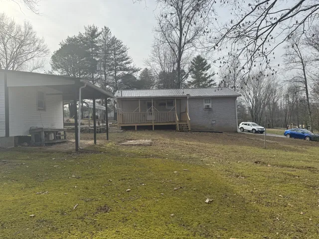 a backyard of a house with oven and trees