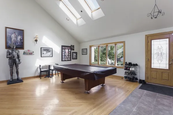a living room with furniture large window and wooden floor