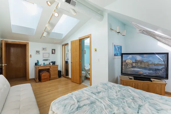 a bedroom with a bed and a flat screen tv