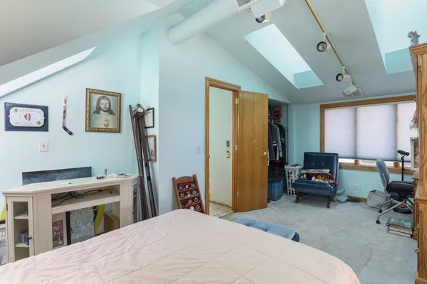 a bedroom with a bed and a couch