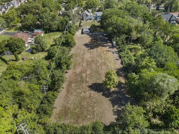 an aerial view of a house with a yard and lake view