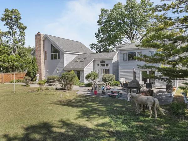 a view of a house with backyard porch and sitting area