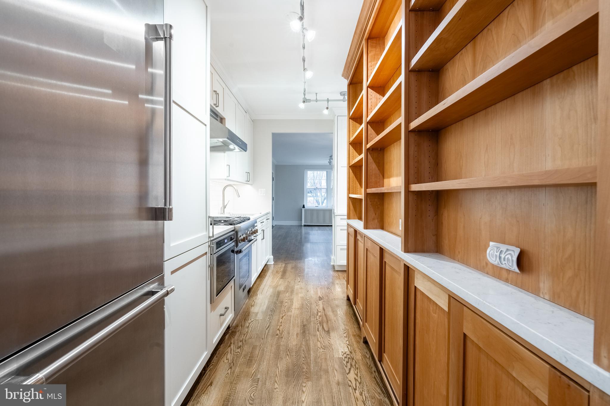1127 C Street Southeast, Unit 1 Washington, DC 20003 - Photo 11 of 26 a view of a kitchen with wooden floor and a window
