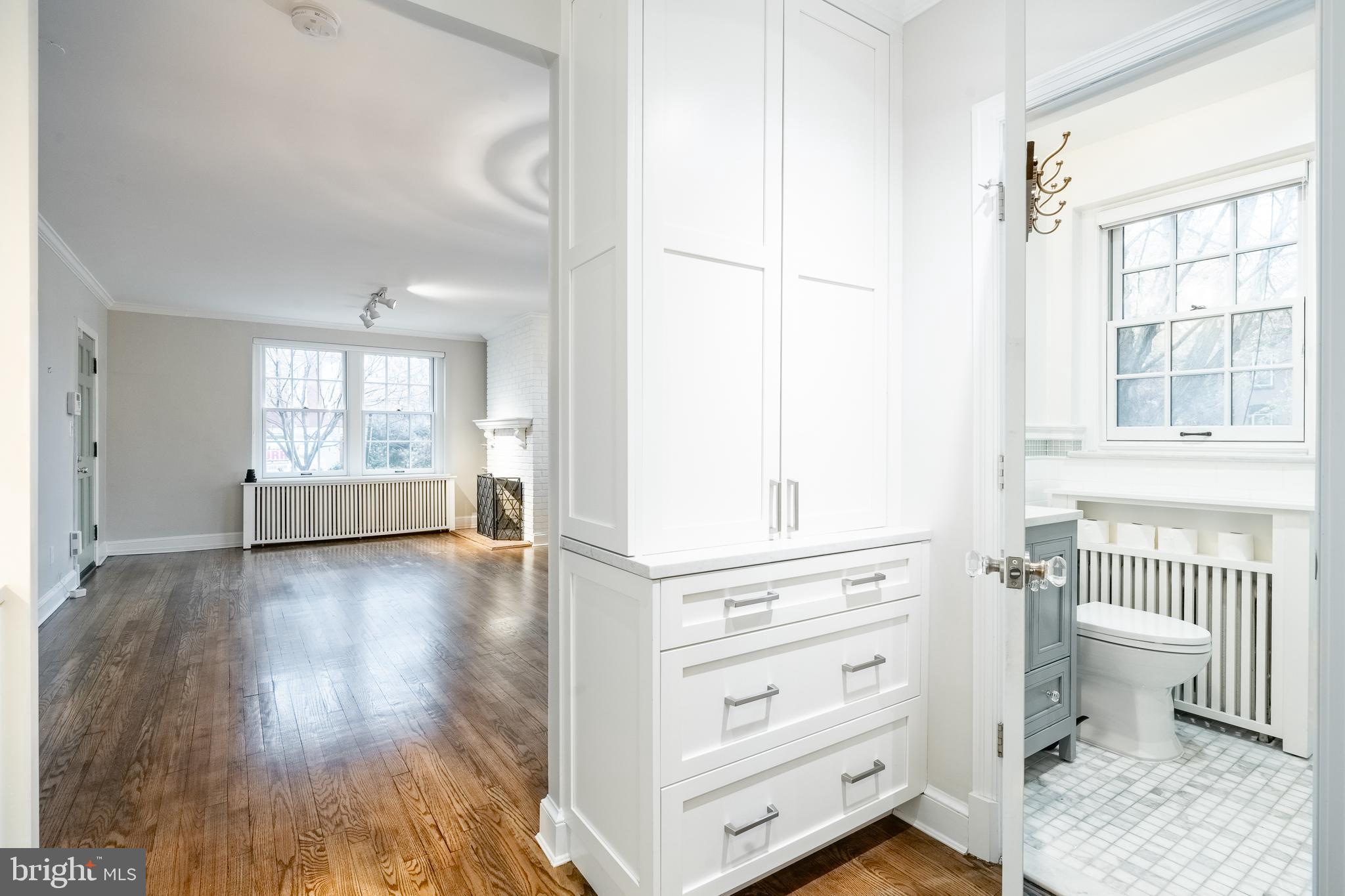 1127 C Street Southeast, Unit 1 Washington, DC 20003 - Photo 13 of 26 a view of a bedroom with wooden floor and windows