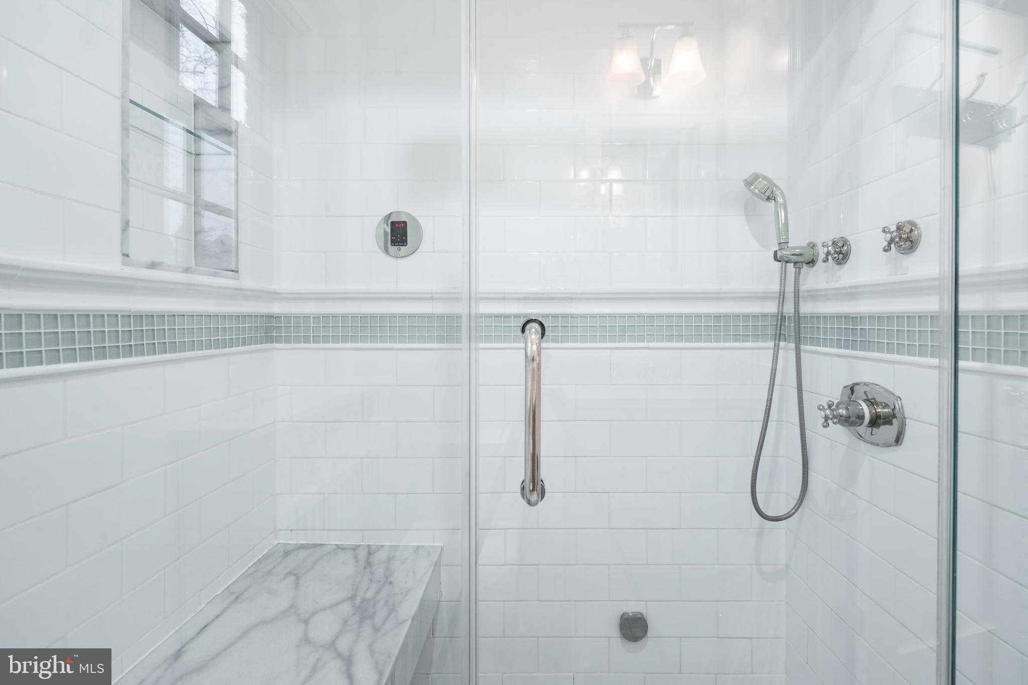 1127 C Street Southeast, Unit 1 Washington, DC 20003 - Photo 16 of 26 a bathroom with a glass shower door