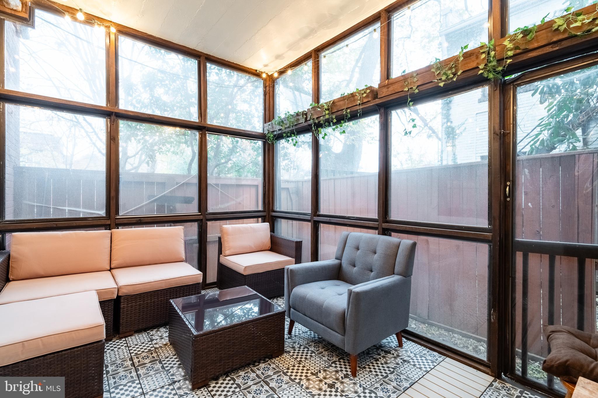 1127 C Street Southeast, Unit 1 Washington, DC 20003 - Photo 23 of 26 a living room with furniture and a floor to ceiling window