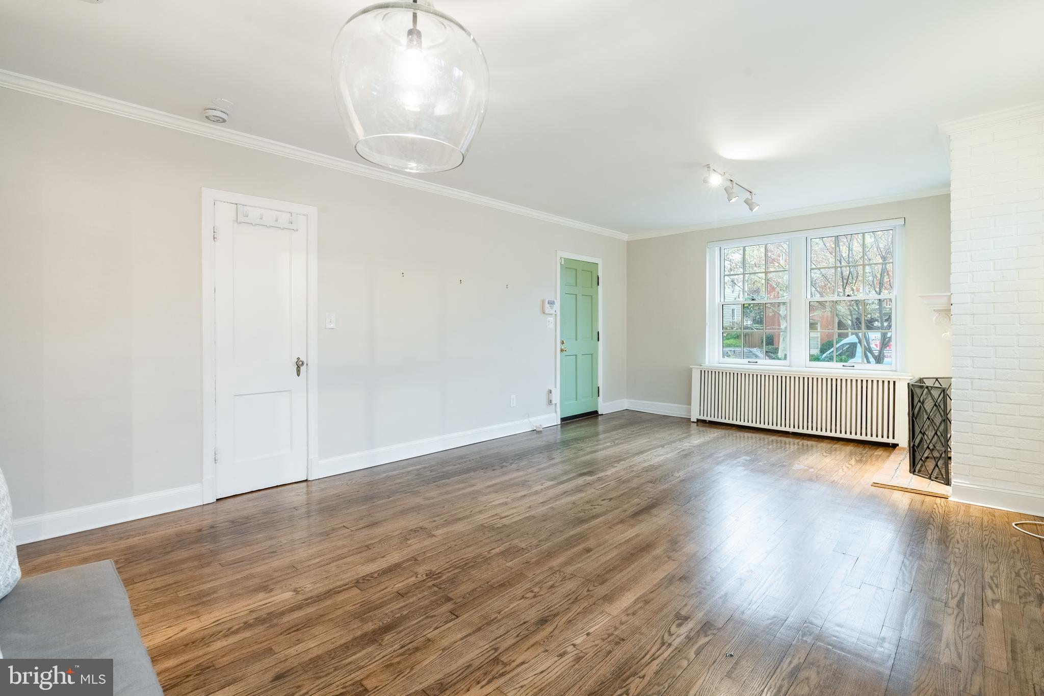 1127 C Street Southeast, Unit 1 Washington, DC 20003 - Photo 3 of 26 an empty room with wooden floor and windows