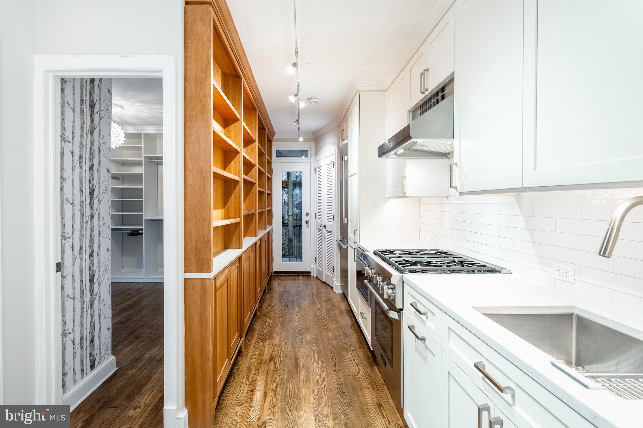 1127 C Street Southeast, Unit 1 Washington, DC 20003 - Photo 9 of 26 a kitchen with stainless steel appliances granite countertop a stove and a sink