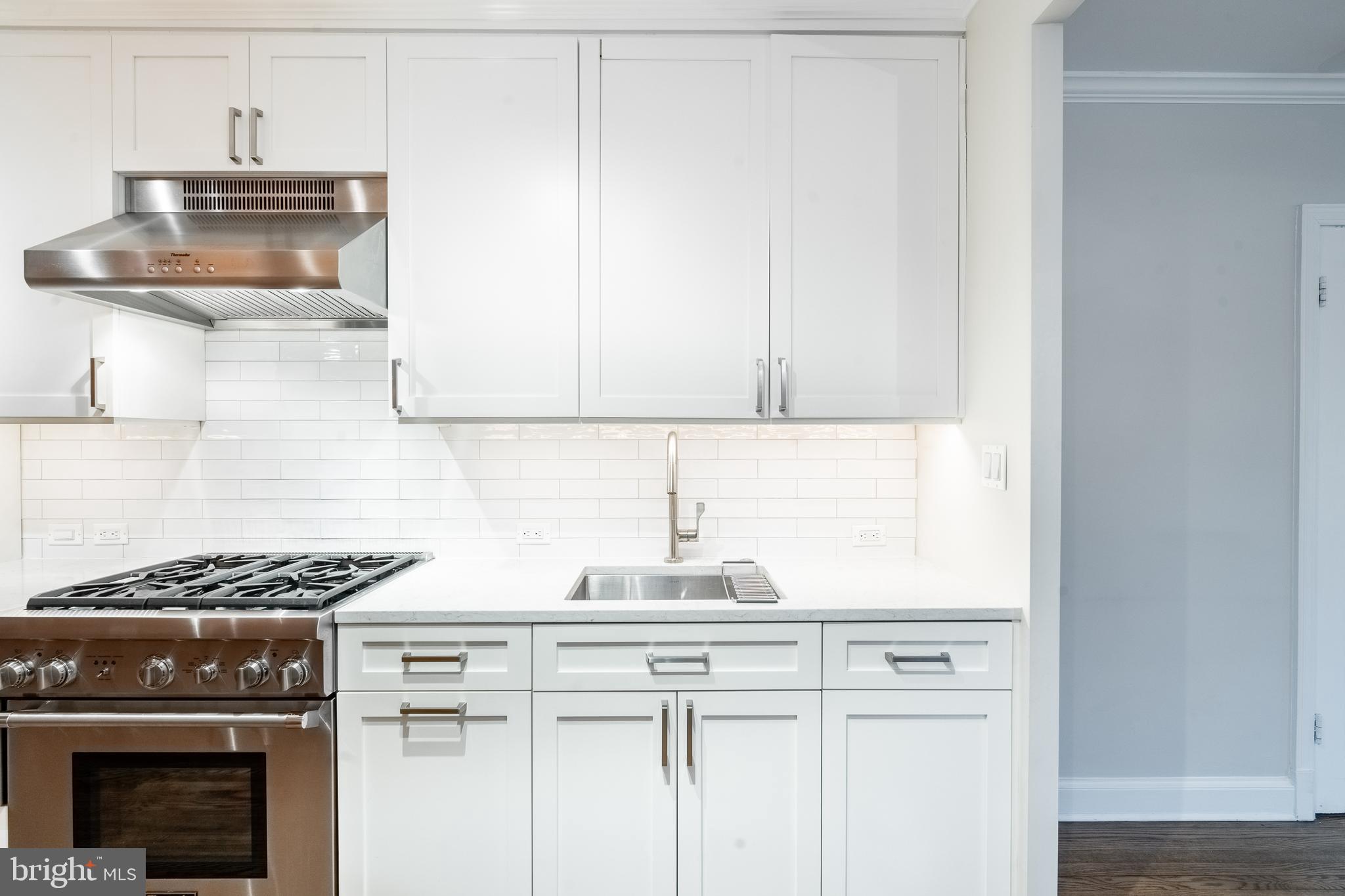 1127 C Street Southeast, Unit 1 Washington, DC 20003 - Photo 10 of 26 a kitchen with granite countertop a stove and a sink