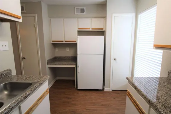 a kitchen with a refrigerator and a sink