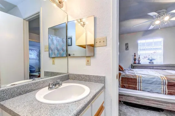 a en suite bathroom with a sink and a mirror