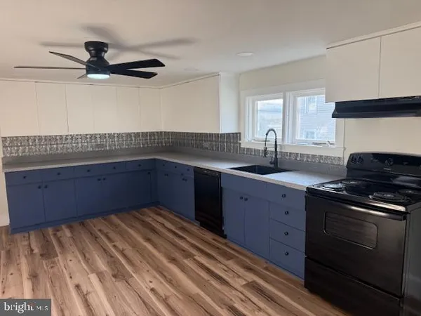 a kitchen with a sink and cabinets