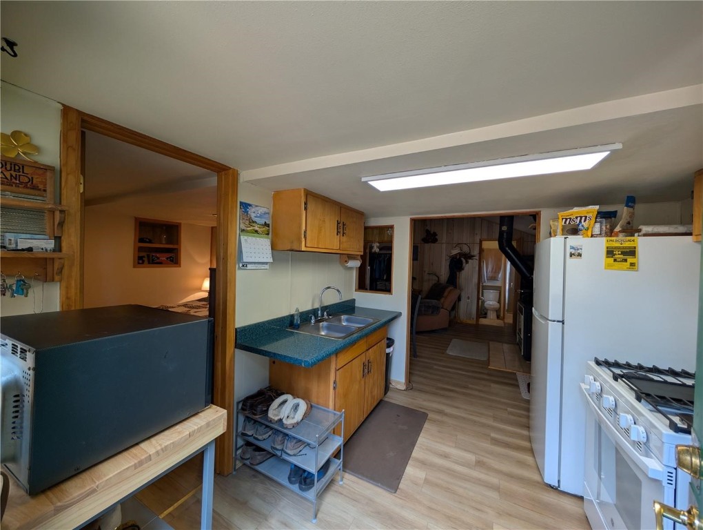 2117 Badger Creek Road Hartsel, CO 80449 - Photo 12 of 46 a kitchen view with wooden floor and cabinets