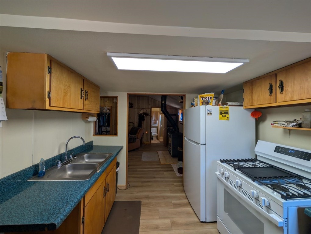 2117 Badger Creek Road Hartsel, CO 80449 - Photo 15 of 46 a kitchen with granite countertop a sink a stove and refrigerator