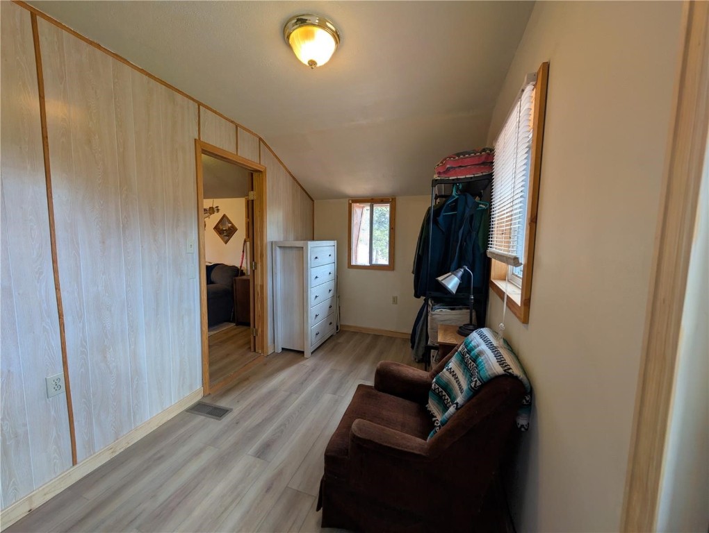 2117 Badger Creek Road Hartsel, CO 80449 - Photo 19 of 46 a view of a hallway with wooden floor and staircase