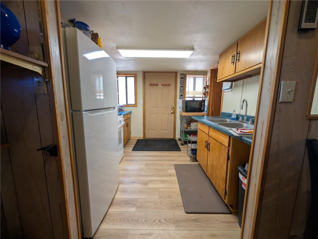 2117 Badger Creek Road Hartsel, CO 80449 - Photo 23 of 46 a hallway with sink and wooden floor
