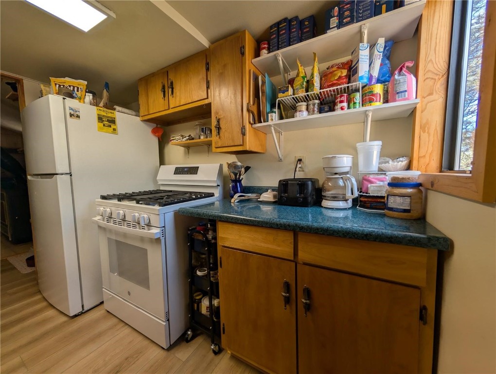 2117 Badger Creek Road Hartsel, CO 80449 - Photo 25 of 46 a kitchen with stainless steel appliances a stove a sink and a refrigerator