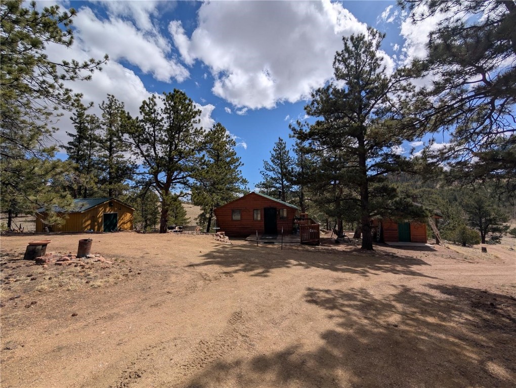 2117 Badger Creek Road Hartsel, CO 80449 - Photo 3 of 46 a wooden bench sitting in middle of a snow