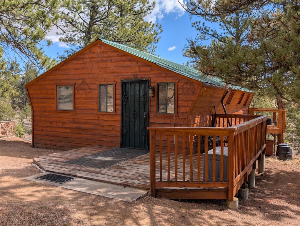 2117 Badger Creek Road Hartsel, CO 80449 - Photo 4 of 46 a view of wooden house with a small yard and wooden fence