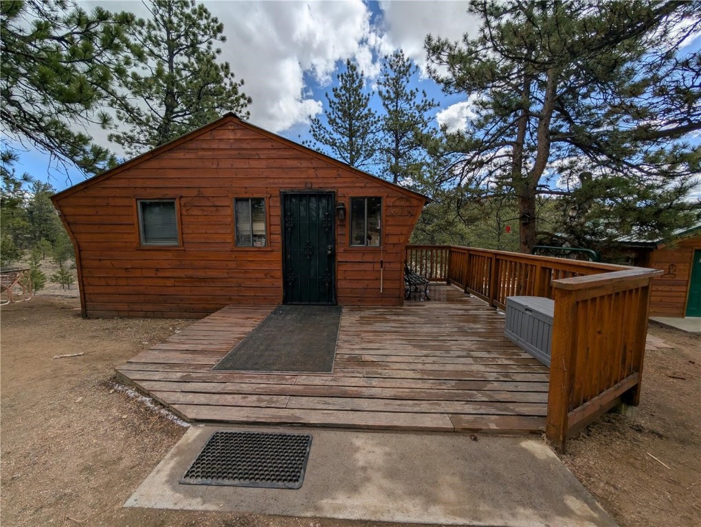 2117 Badger Creek Road Hartsel, CO 80449 - Photo 6 of 46 a view of a wooden house with a small yard