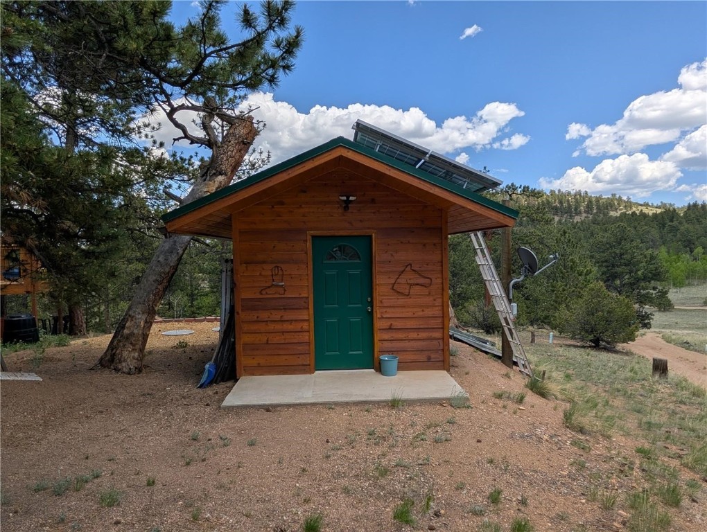 2117 Badger Creek Road Hartsel, CO 80449 - Photo 7 of 46 a front view of a house with garden