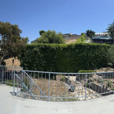 a view of a balcony with floor to ceiling window and outdoor space