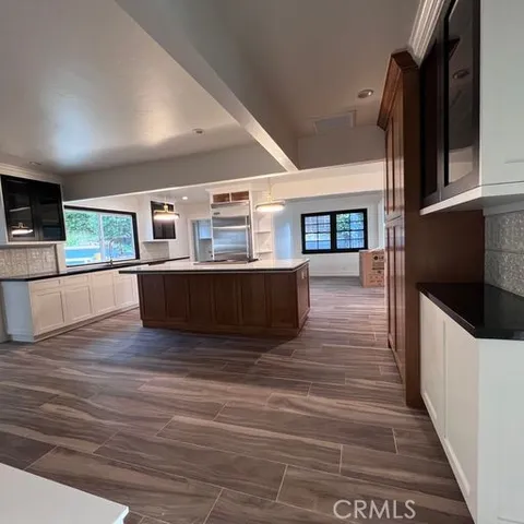 a living room with stainless steel appliances furniture or kitchen view and a windows